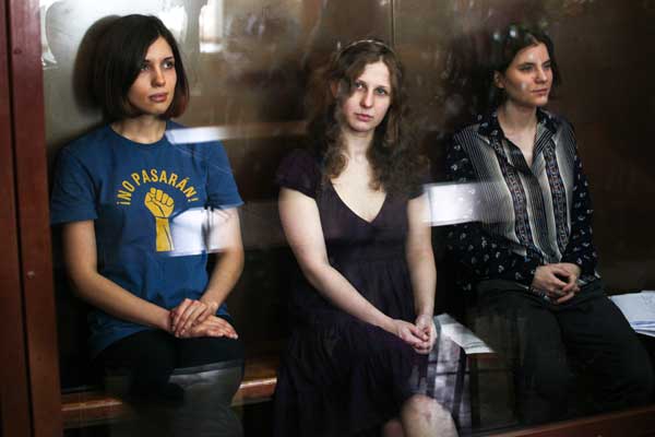 Feminist punk group Pussy Riot members, Nadezhda Tolokonnikova (left), Maria Alekhina (centre) and Ekaterina Samutsevich (right) sit in a glass cage at a court room in Moscow. Maria Pleshkova | Demotix