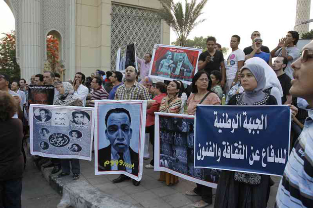 Egyptian intellectuals hold posters and the Tamarod (Rebellion) petitions while chanting slogans during a demonstration against the Minister of Culture Alaa Abdel Aziz, in front of the opera house in Cairo. (Photo: Mohamed Elmaymony / Demotix)