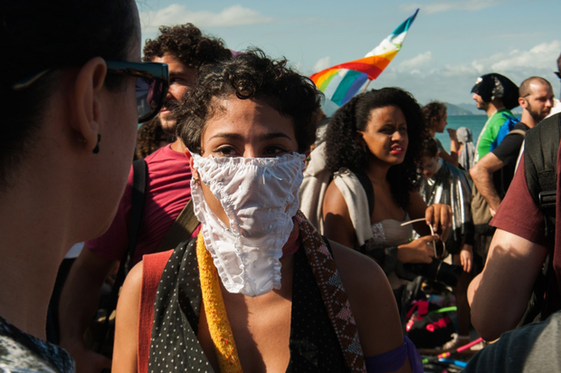 A demonstrator disguises her face during a the "March of the Sluts" in Rio de Janeiro. (Photo: Vito Di Stefano / Demotix)