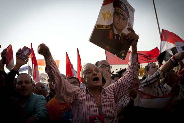 A protester holds a portrait of General Abdel Fattah al-Sisi during protests in July. (Shawkan / Demotix)