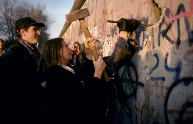A woman chips away at the Berlin Wall, November 1989. Credit: Justin Leighton / Alamy