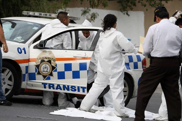 Medical forensic officers investigate clues after six murdered in a day of organised crime in Monterrey - 11/07/2012 Demotix - Victor Hugo Valdivia