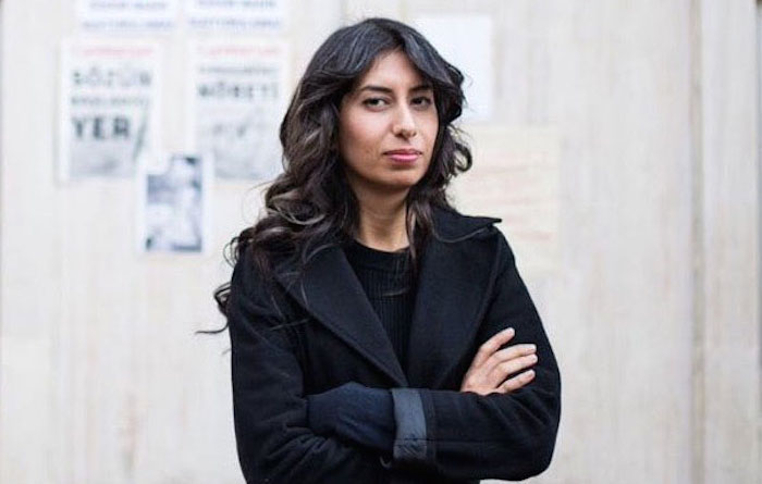 Turkish journalist Canan Coskun stands with her arms folded