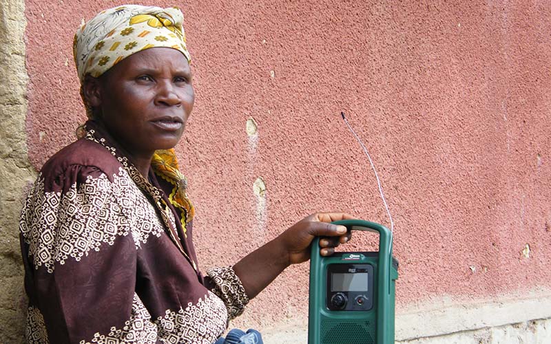 A Rwandan woman listens to her radio. (Image: Peter Kettler)