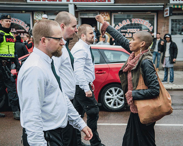 Tess Asplund faces protesters from the Nordic Resistance Movement in Borlänge, Sweden, in May 2016