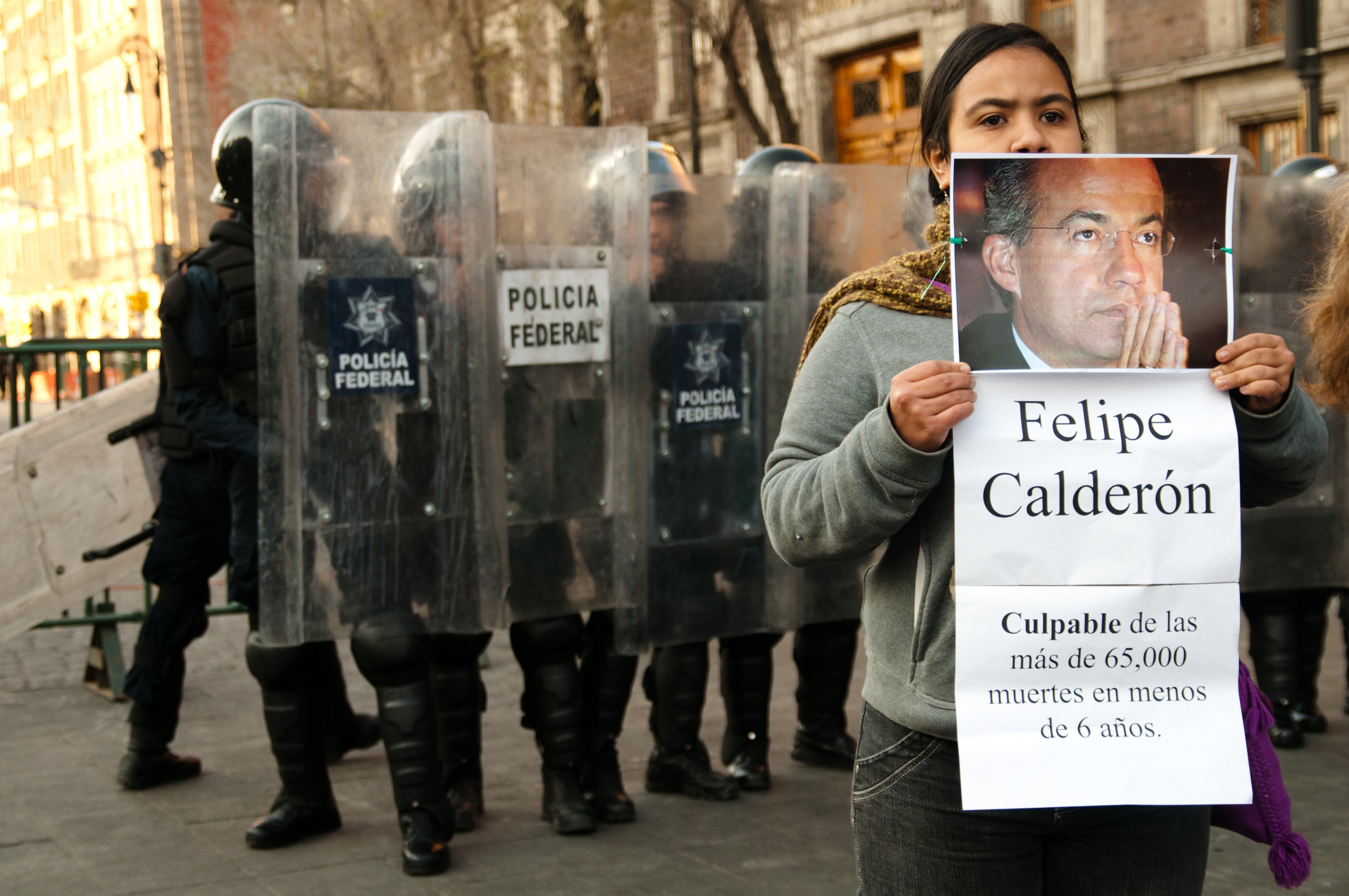 Activists from the Movement for Peace with Justice and Dignity held a peaceful protest in front of the Zocalo in Mexico City, 2011, during the flag raising ceremony where they held up photos of public figures who the group felt were not worthy to raise the flag, Eneas De Troya/Flickr