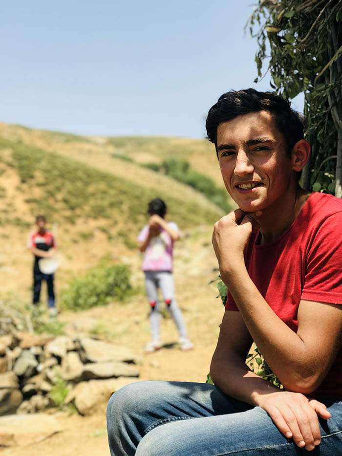 İdris Sayılgan’s 18-year-old İsmail who guided us to the meadow, with Hivda and Yunus in the background. (Credit: Mezopotamya Agency)