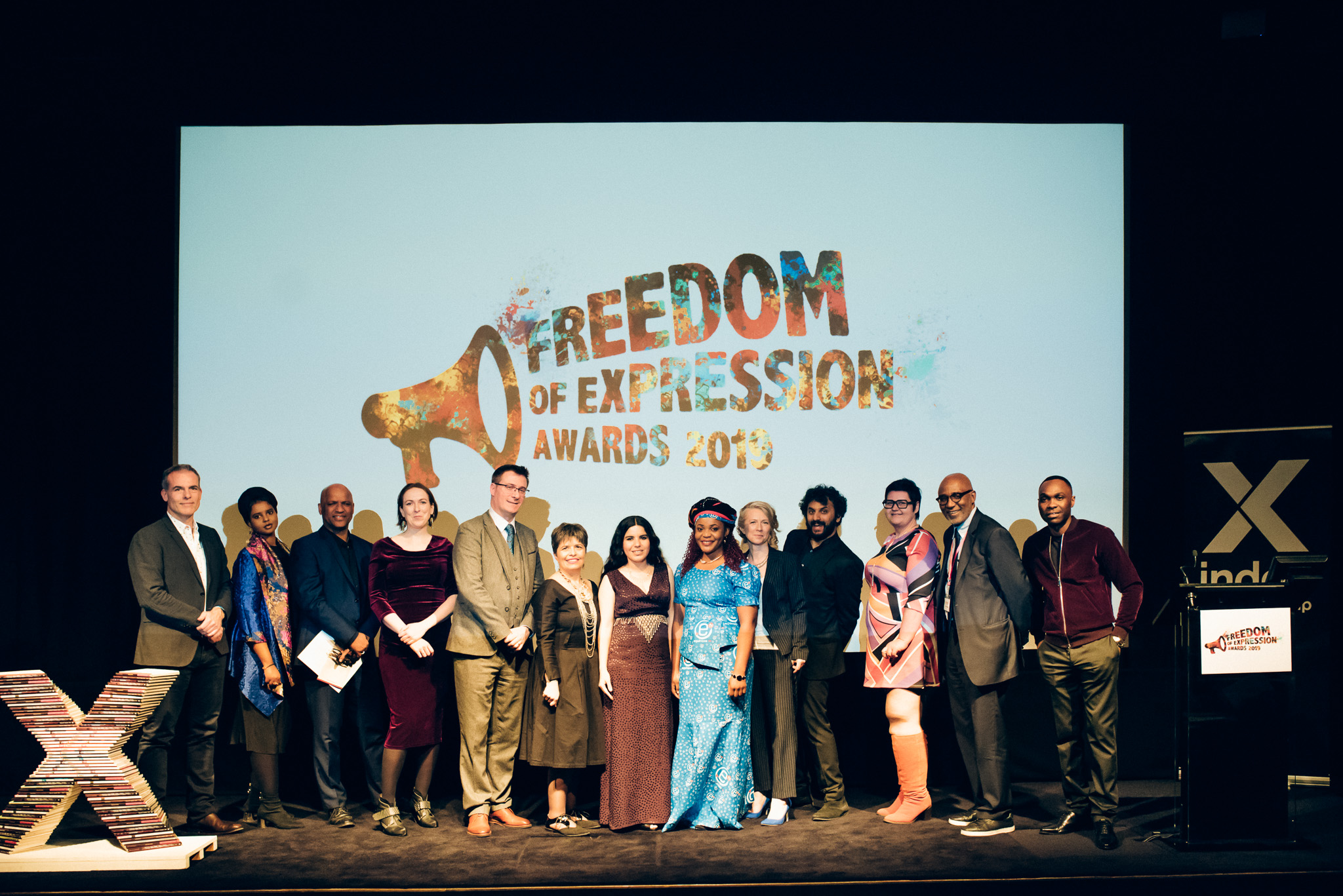 Presenters and award winners at the 2019 Freedom of Expression Awards (from left): Ziyad Marar, president of global publishing, Sage Publishing; Momtaza Mehri, Young People’s Laureate for London; Mark Sealy, Director of Autograph Gallery; Kate Devlin, writer and academic; Terry Anderson, deputy executive director of campaigning award-winning Cartoonist Rights Network International; Carolina Botero Cabrera, executive director of digital activism award-winning Fundación Karisma; Arts award-winning artist Zehra Doğan; Journalism award-winning journalist Mimi Mefo; CEO of Index on Censorship Jodie Ginsberg; Host the awards, comedian Nish Kumar; Christel Dahlskjaer, Director of Outreach at Private Internet Access; Chair of Index on Censorship Trevor Phillips; Otis Tabasenge of the band Kasai Masai. (Photo: Elina Kansikas for Index on Censorship)
