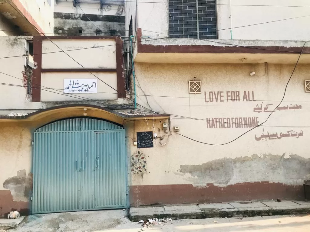 The gate of an Ahmadiyya community building with the words "Love for all; Hatred for none" written on the wall.
