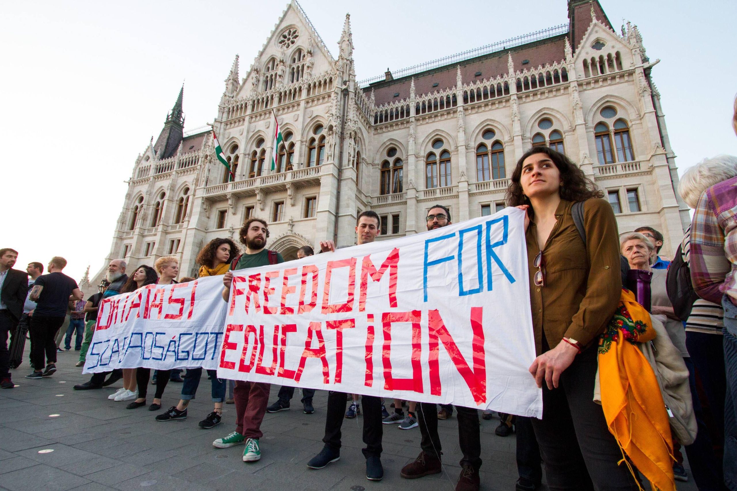 Demonstrators hold a sign saying "Freedom for education"