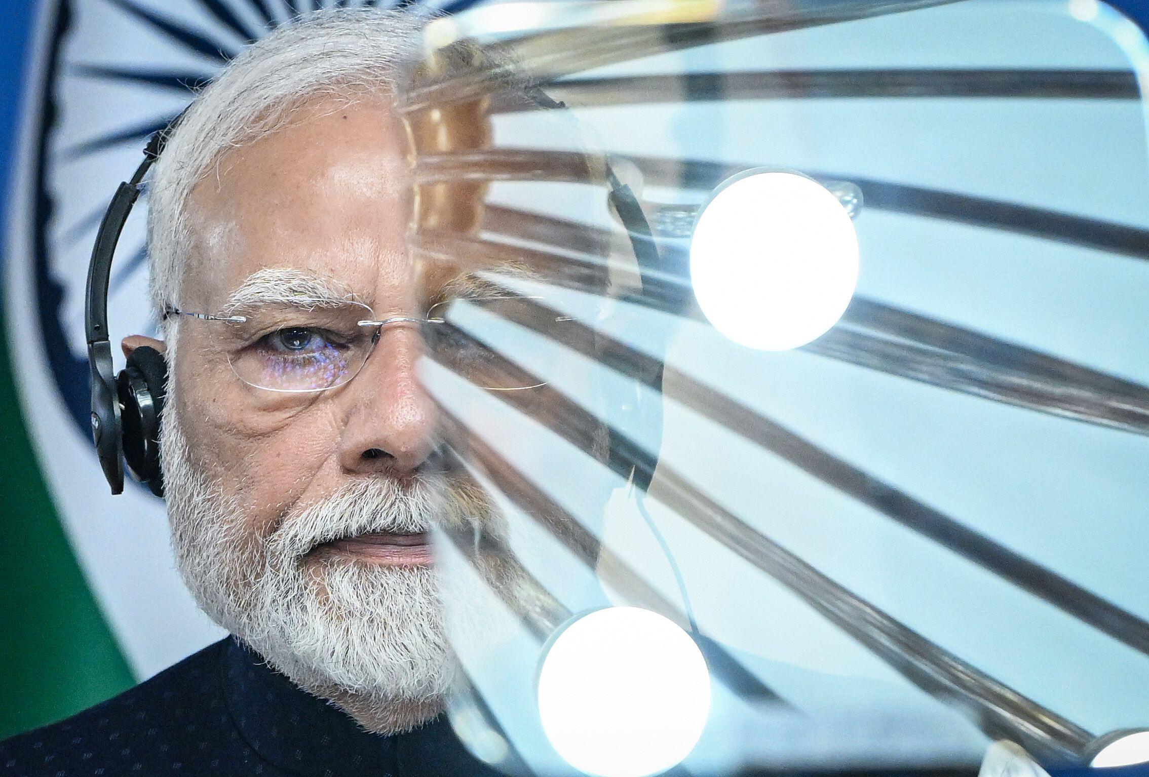 Prime Minister Narendra Modi, wearing headphones